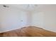 Bright bedroom features hardwood floors, ceiling fan, and white closet doors at 8713 E Sage Dr, Scottsdale, AZ 85250