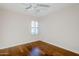 Bedroom with beautiful hardwood floors and a shuttered window for natural light at 8713 E Sage Dr, Scottsdale, AZ 85250
