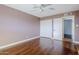 Bedroom with hardwood floors, closet, ceiling fan, and neutral colored walls at 8713 E Sage Dr, Scottsdale, AZ 85250