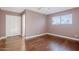 Bedroom featuring hardwood floors, closet, and neutral colored walls at 8713 E Sage Dr, Scottsdale, AZ 85250