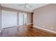 Bedroom with hardwood floors, closet, ceiling fan, and neutral colored walls at 8713 E Sage Dr, Scottsdale, AZ 85250