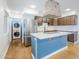 Well-lit kitchen with stainless steel appliances, an island, and a convenient laundry area at 8713 E Sage Dr, Scottsdale, AZ 85250