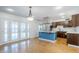 Modern kitchen featuring a functional island and ample cabinet space, open to the living area at 8713 E Sage Dr, Scottsdale, AZ 85250