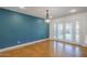 Living area featuring a teal accent wall and glass doors leading to the outdoor space at 8713 E Sage Dr, Scottsdale, AZ 85250