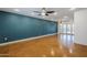 Spacious living room with a blue accent wall and access to the backyard through French doors at 8713 E Sage Dr, Scottsdale, AZ 85250