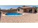 Backyard with a sparkling pool, rock landscaping, and desert-friendly plants at 9243 W Brown St, Peoria, AZ 85345