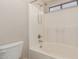 Full white tub and shower combination with brushed metal plumbing at 9243 W Brown St, Peoria, AZ 85345