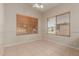 Bright bedroom features tile flooring, neutral walls, ceiling fan and dual windows with wood-style blinds at 9243 W Brown St, Peoria, AZ 85345