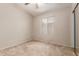 Bedroom with neutral walls, plush carpet, and a window providing natural light at 9243 W Brown St, Peoria, AZ 85345