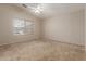 Spacious carpeted bedroom with natural light from a large window at 9243 W Brown St, Peoria, AZ 85345