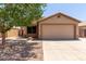 Charming single-story home featuring a two-car garage, landscaped yard and mature shade tree on a sunny day at 9243 W Brown St, Peoria, AZ 85345