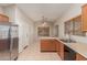 Bright kitchen featuring a stainless steel refrigerator and breakfast bar at 9243 W Brown St, Peoria, AZ 85345