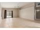 Spacious living room features neutral walls, tile flooring, ceiling fan, and sliding glass door to the backyard at 9243 W Brown St, Peoria, AZ 85345