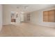 Open-concept living room with tile flooring, neutral walls and a view of the front door and kitchen at 9243 W Brown St, Peoria, AZ 85345