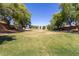 Scenic community park with lush green grass, mature trees, and plenty of open space for activities at 9243 W Brown St, Peoria, AZ 85345