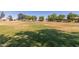 Expansive community park featuring a large grassy area, mature trees, and recreational facilities at 9243 W Brown St, Peoria, AZ 85345