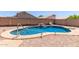 Backyard pool with rock waterfall feature and desert landscaping at 9243 W Brown St, Peoria, AZ 85345