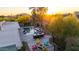 Aerial view of a backyard with a pool, outdoor kitchen, and fire pit area surrounded by desert landscaping at 9432 E Quail Trl, Carefree, AZ 85377