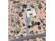 An aerial view of a home with a swimming pool and desert landscaping at 9432 E Quail Trail, Scottsdale, AZ at 9432 E Quail Trl, Carefree, AZ 85377