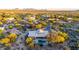 Expansive aerial view showcasing a desert home with a pool surrounded by native vegetation at 9432 E Quail Trl, Carefree, AZ 85377