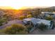 Stunning aerial view of a desert home with desert landscaping and a private drive at sunset at 9432 E Quail Trl, Carefree, AZ 85377