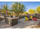 Spacious backyard featuring a built-in BBQ grill and cozy seating area with a fire pit for outdoor gatherings at 9432 E Quail Trl, Carefree, AZ 85377
