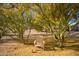 Backyard featuring desert trees, foliage, decorative stone and an Adirondack chair at 9432 E Quail Trl, Carefree, AZ 85377
