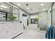 Bright bathroom featuring dual sinks, marble countertops, modern tub, and a glass-enclosed shower at 9432 E Quail Trl, Carefree, AZ 85377