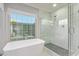 Bathroom featuring a modern standalone tub and glass enclosed shower with natural light at 9432 E Quail Trl, Carefree, AZ 85377
