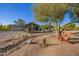 Desert home featuring a long driveway, xeriscaping, and wood Adirondack chairs at 9432 E Quail Trl, Carefree, AZ 85377