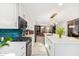 Bright kitchen featuring long island, stainless steel appliances, white cabinets, and modern backsplash at 9432 E Quail Trl, Carefree, AZ 85377