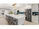Updated kitchen features large island with seating, stainless appliances, and modern blue backsplash at 9432 E Quail Trl, Carefree, AZ 85377