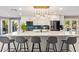 Modern kitchen features a waterfall island with seating, stainless steel appliances, and stylish lighting at 9432 E Quail Trl, Carefree, AZ 85377