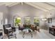 Living room featuring vaulted ceilings, wood flooring, and lots of natural light at 9432 E Quail Trl, Carefree, AZ 85377