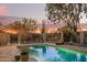 Inviting backyard with a pristine pool, desert plants, and comfortable lounge seating for relaxation at 9432 E Quail Trl, Carefree, AZ 85377