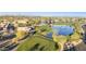 Breathtaking aerial view of a golf course community with lush green fairways, water features and distant mountains at 10102 E Michigan Ave, Sun Lakes, AZ 85248