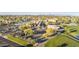 Aerial shot of community featuring a golf course, mature trees, parking, and meticulously kept grounds at 10102 E Michigan Ave, Sun Lakes, AZ 85248