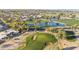 Stunning aerial shot highlighting a golf course with lakes and a well-planned residential community beyond the green at 10102 E Michigan Ave, Sun Lakes, AZ 85248