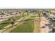 Scenic aerial view showcasing a lush golf course winding through a community with mature trees and well-maintained homes at 10102 E Michigan Ave, Sun Lakes, AZ 85248