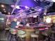 Bar area with patrons, bar stools, and a view of the Cardinals logo at 10102 E Michigan Ave, Sun Lakes, AZ 85248