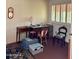 Simple bedroom with a collection of furniture, shuttered windows, and carpet flooring at 10102 E Michigan Ave, Sun Lakes, AZ 85248