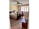 Bedroom features a ceiling fan, window with shutters, a bed, and an area rug at 10102 E Michigan Ave, Sun Lakes, AZ 85248