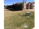 Well-maintained front yard with lush green lawn and mature landscaping creates a welcoming curb appeal at 10102 E Michigan Ave, Sun Lakes, AZ 85248
