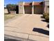 Spacious two-car garage with a wide driveway and beautifully landscaped front yard at 10102 E Michigan Ave, Sun Lakes, AZ 85248