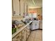 Functional kitchen with wood cabinets, tile flooring, and ample counter space at 10102 E Michigan Ave, Sun Lakes, AZ 85248