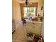 Practical kitchen area with tile flooring, corner dining area, and natural light at 10102 E Michigan Ave, Sun Lakes, AZ 85248