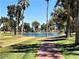 Scenic view of a pond surrounded by lush greenery and walking paths at 10102 E Michigan Ave, Sun Lakes, AZ 85248