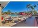 Inviting pool area with tables, chairs, and umbrellas, perfect for outdoor entertaining at 10102 E Michigan Ave, Sun Lakes, AZ 85248
