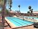 Relaxing pool with palm trees and lounge chairs for a leisurely day in the sun at 10102 E Michigan Ave, Sun Lakes, AZ 85248