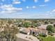 Wide aerial shot showcases the home's surroundings, including a pool and neighborhood at 10205 E Corrine Dr, Scottsdale, AZ 85260